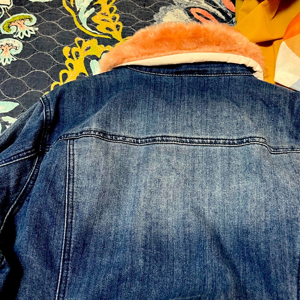 Lovely jean jacket with pink fur collar. Has beautiful buttons trim.